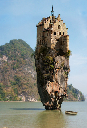 castle on rock in water