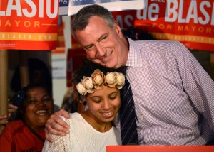 New York mayoral candidate Bill de Blasio embraces his daughter Chiara during a campaign rally in Brooklyn, New York